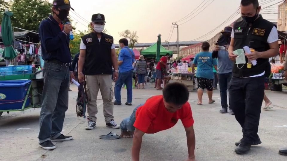 A file photo of a man in Nonthaburi province ordered by officials to do push-ups for not wearing a face mask in public. 
