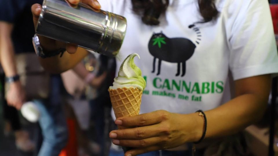 A vendor pours cannabis powder onto a cannabis-infused ice-cream at a cannabis event held in Buriram. Photo: Medical Cannabis Institute