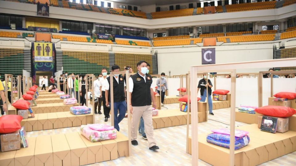 Cardboard boxes were made into makeshift beds for COVID-19 patients Sunday at the Bangkok Arena Sports Center. Photo: BMA