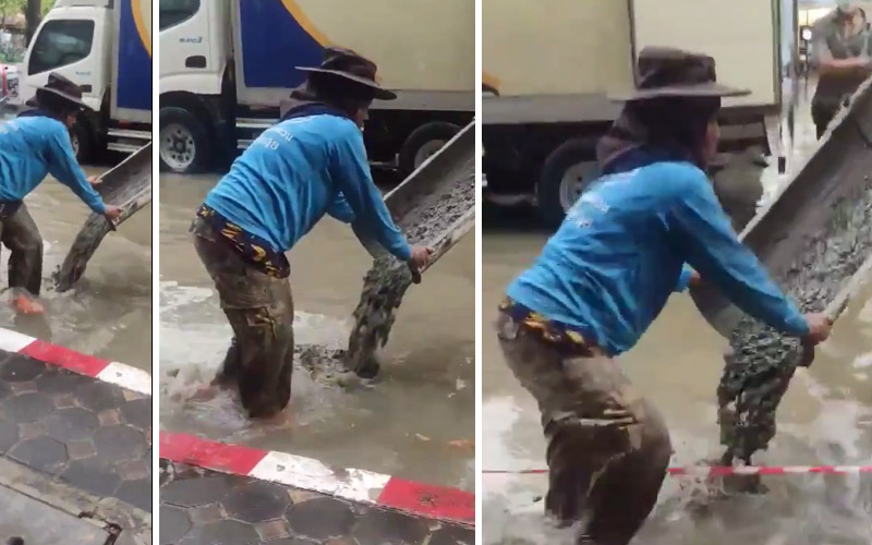 No shouts of concern were going to stop this worker from dropping cement into this road-lake created by Tuesday’s fierce storm in Bangkok. Images from video republished with permission of Facebooker Ipod Manjasannoi.