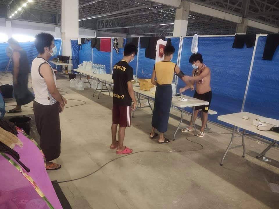 A photo of Cal-Comp workers checking each other’s blood pressure. Photo: Than Zaw Htike / Courtesy