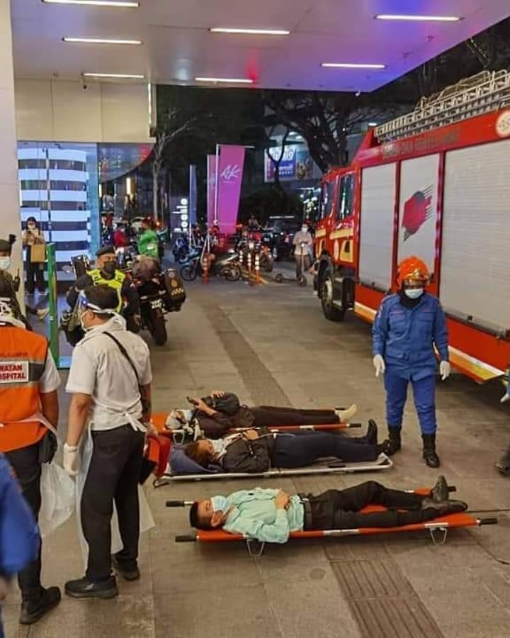 People lying on stretchers outside the KLCC train station. Photo: KL Fire and Rescue Department