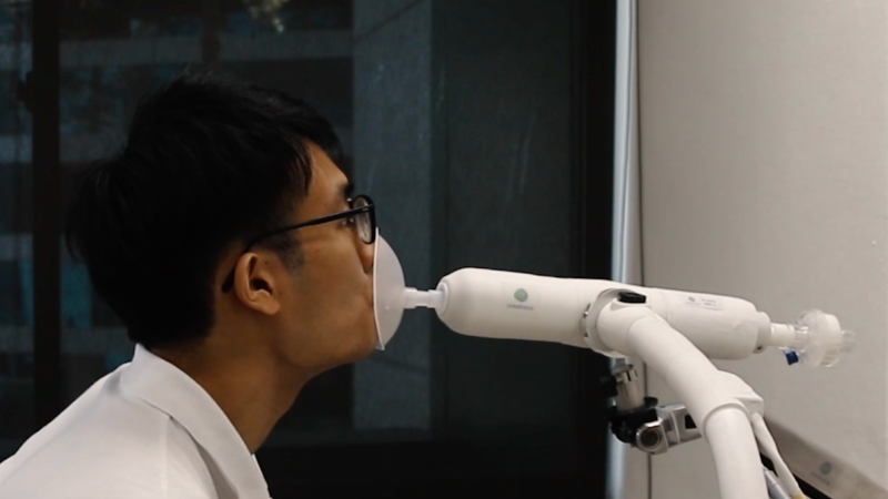 A man undergoes a breath test in a promotional video for a new COVID-19 breathalyzer. Photo: Breathonix Pte Ltd
