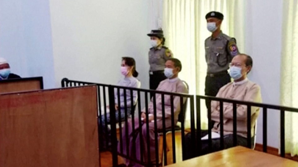 File photo of ousted State Counsellor Aung San Suu Kyi, seated at left, alongside former president Win Myint and doctor Myo Aung appear at a court in Naypyitaw, Myanmar, on May 24, 2021. Image: MRTV