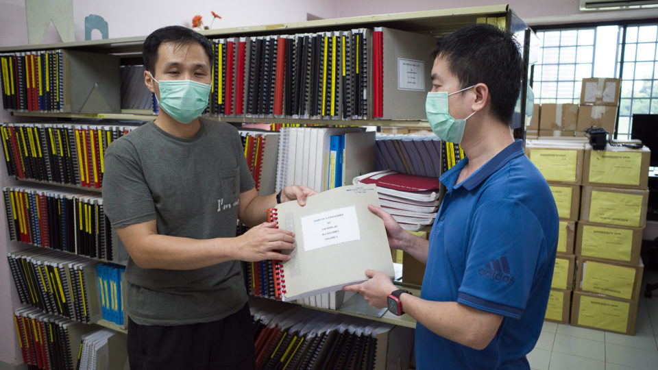 Librarian Kelvin Tan and braille transcriber Jason Setok of the Braille Production Center at the Singapore Association Of The Visually Handicapped. Photo: Coconuts 
