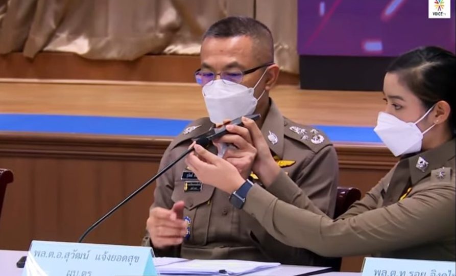 Police spokeswoman Lt. Patarasaya Rerkrut helps national police chief Gen. Suwat Jangyodsuk at an Aug. 26 news conference.
