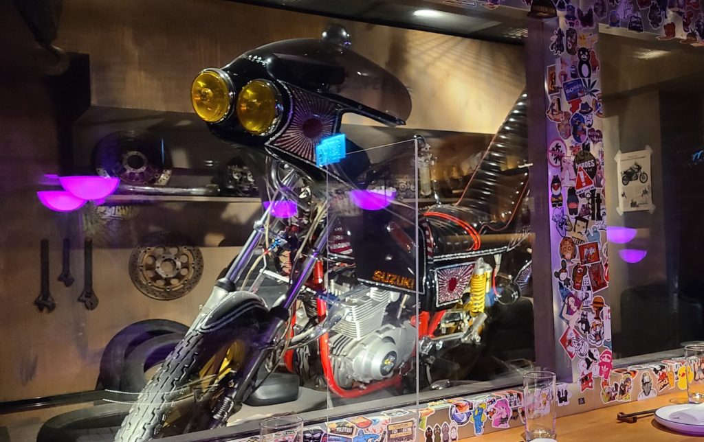 We had front row seats to a blinged up motorbike at our bar table. Photo: Coconuts Media