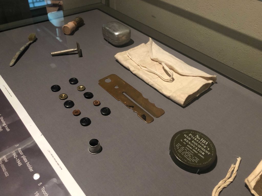 The British military kit contained items like buttons, button polisher, toothbrush, razor, and shaving brush.