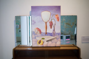 “Other Faces” by Hee Suhui atop a vanity table. Photo: Carolyn Teo/Coconuts