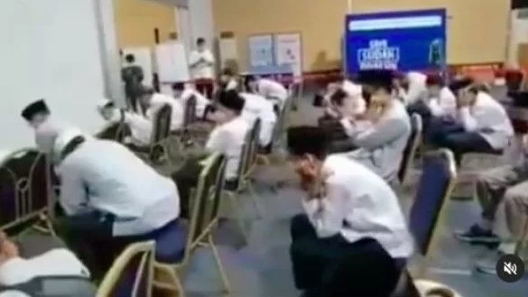 Islamic boarding school students in Indonesia covering their ears to block out the sound of music. Photo: Video screengrab