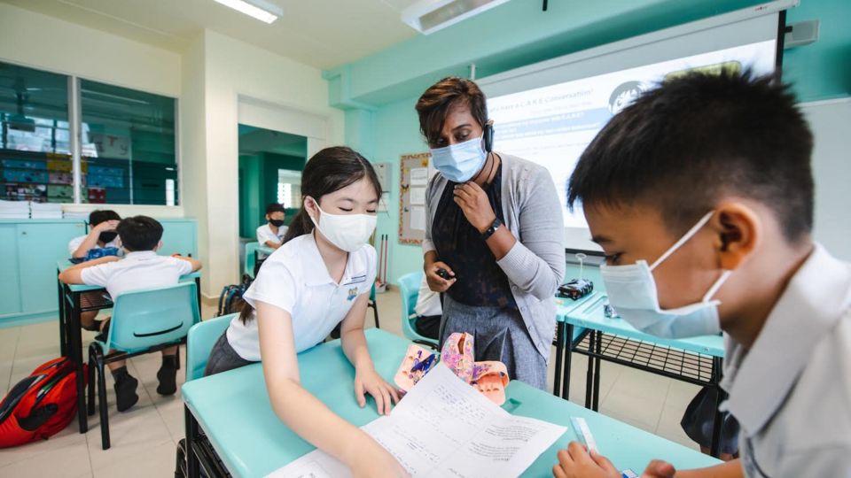 A teacher assisting students at a primary school. Photo: Chan Chun Sing/Facebook