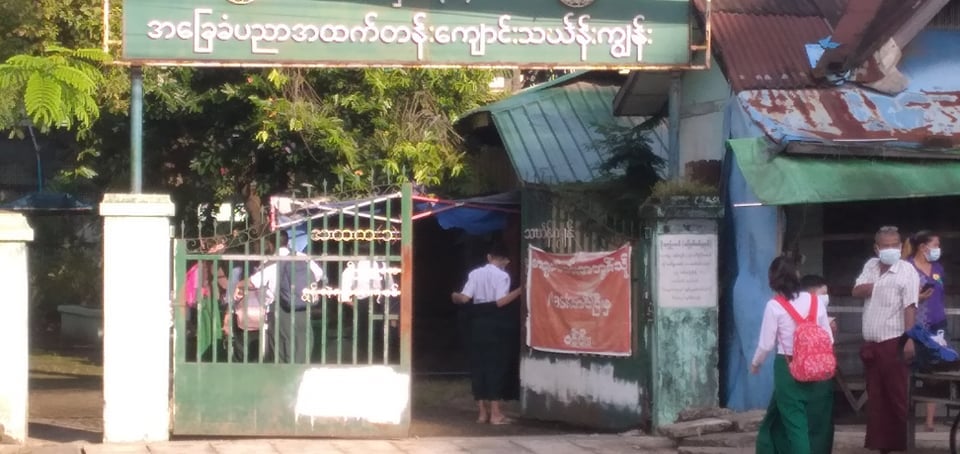 Students change into uniforms upon arrival Monday morning to a school in Yangon’s Thingyanugan Township. Photo: Mercury Media