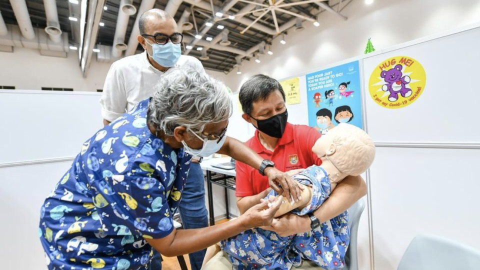 Education Minister Chan Chun Sing comforts a dummy receiving a jab yesterday at a pediatric center. Photo: Chan Chun Sing/Instagram
