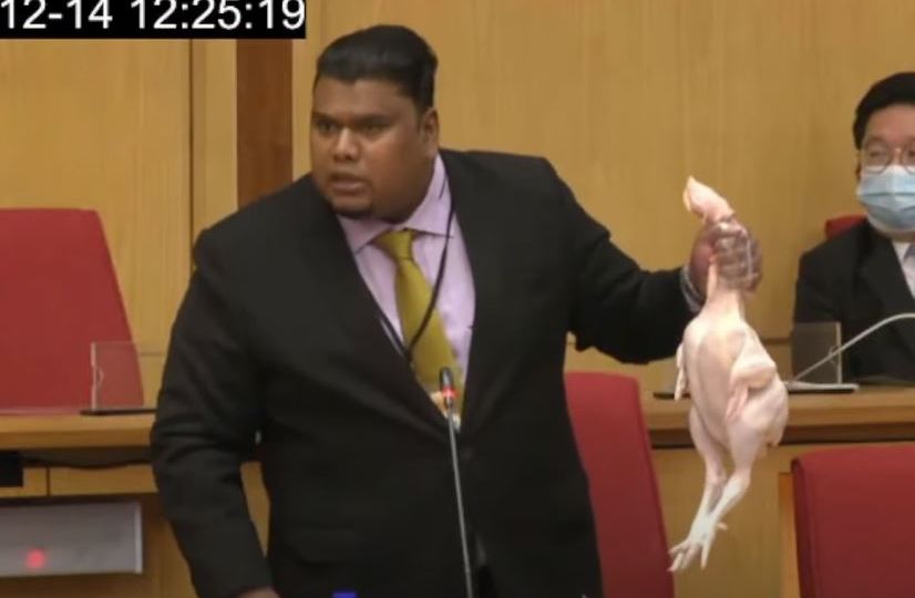 Muhamad Arafat Varisai Mahamad holding up a dead chicken at the Perak state legislative assembly meeting Dec. 14, 2021. Photo: DUN Perak/YouTube
