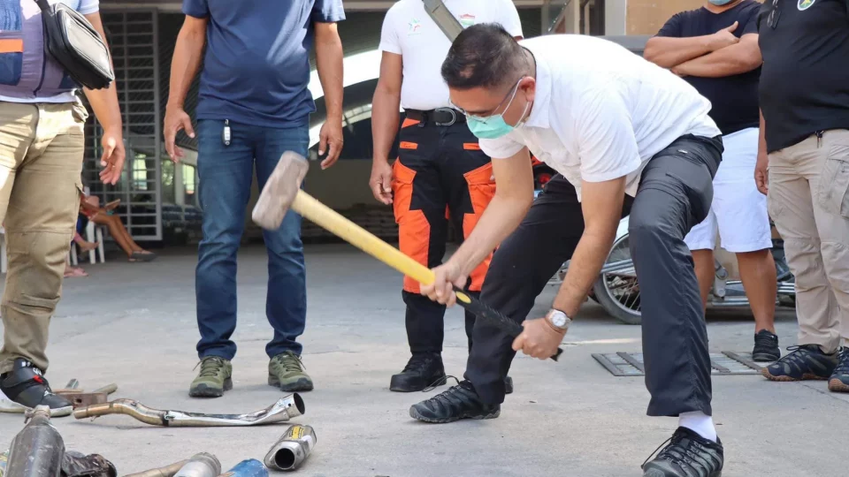 Mayor Jopet Inton of Hermosa, Bataan, smashes confiscated modified mufflers. Image: 1Bataan