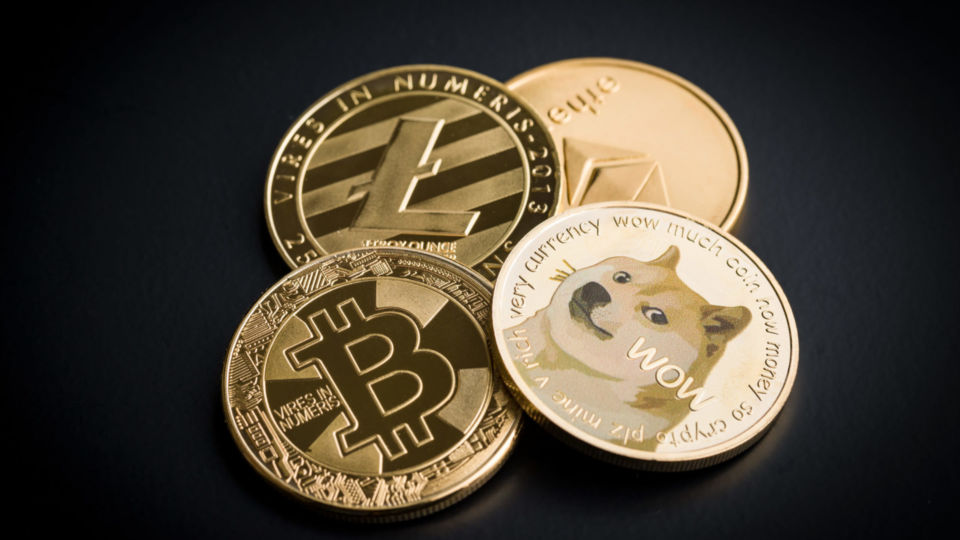 Dogecoin, litecoin, ethereum and bitcoin on black backgrund.