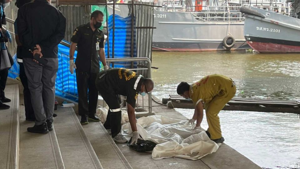 Rescue workers recover the remains of a woman Wednesday in Bangkok.
