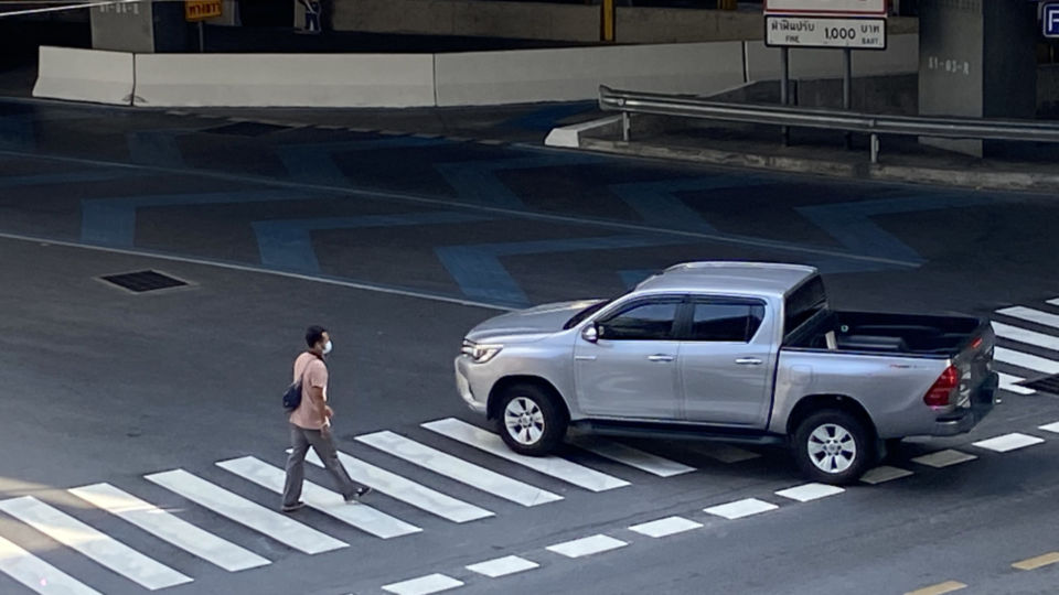 A truck swerves in front of a pedestrian on a Tuesday morning to get on the expressway at Phloen Chit. Photo: Coconuts Bangkok