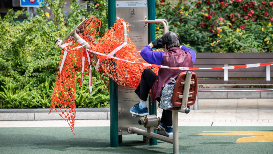 A granny uses a public exercise bike in spite of the government’s closure of such facilities. Feb. 23, 2022. (Photo: Ben Marans Photography) 