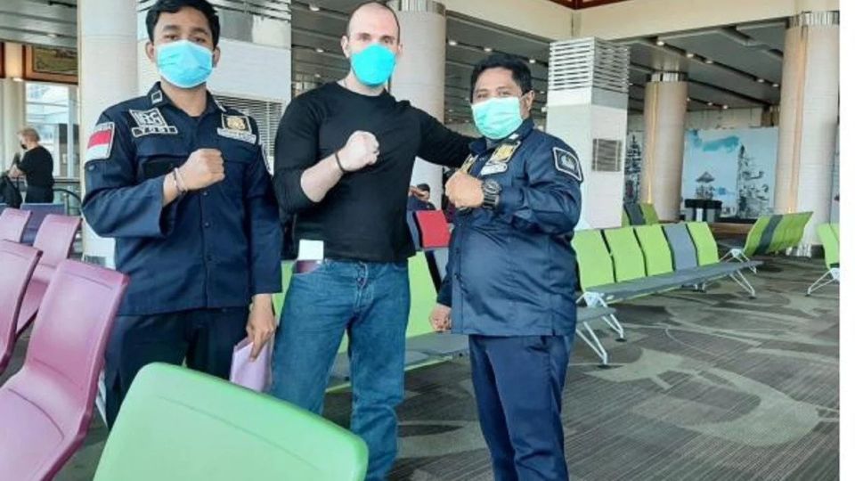 Frenchman RJH pictured with two unnamed officials of the Ministry of Law and Human Rights on March 28, 2022, at the Ngurah Rai International Airport before his deportation. Photo: Obtained. 
