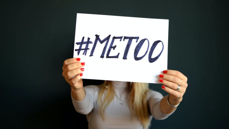 Stock photo of a woman holding #MeToo sign. Credit: Unsplash/Mihai Surdu.