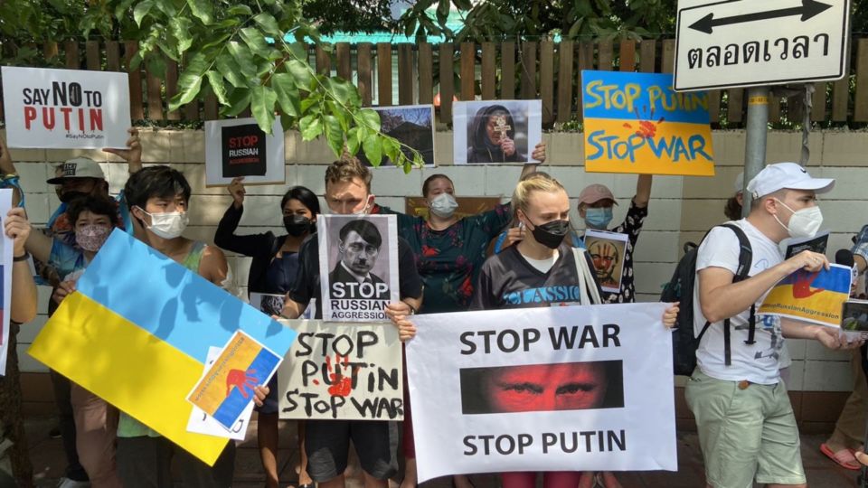 Dozens of protesters on Feb. 25, 2022, assemble outside the Russian embassy in Bangkok’s Silom area where they expressed anger at Russia, fear for their families back home, and hope the international community would intervene. Photo: Nicky Tanskul / Coconuts