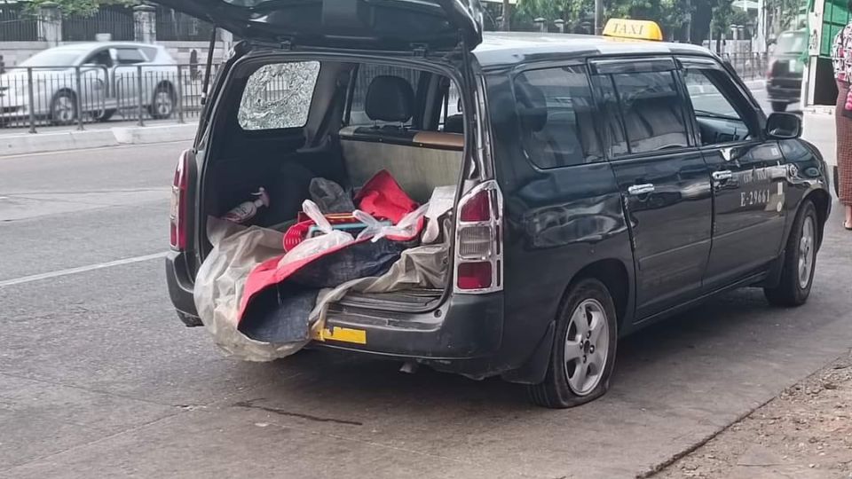 A young man was killed Thursday morning in this bullet-ridden taxi in Kamayut Township. Photo: Nyan Lin Phyo / Facebook