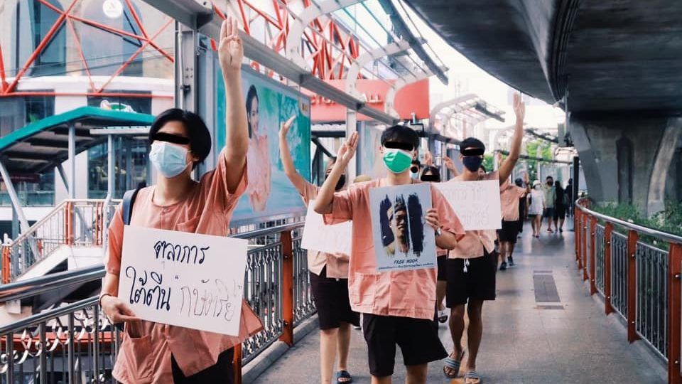 Activists dressed as prison inmates walk on a Bangkok skywalk to protest the justice system. Photo: United Front of Thammasat and Demonstration / Facebook
