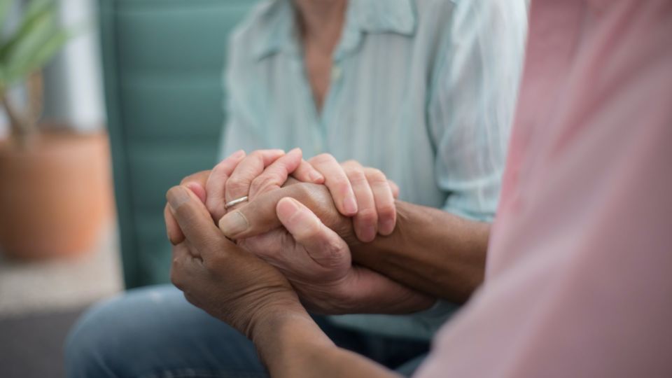 Elderly couple holding hands. Photo by Kampus Production