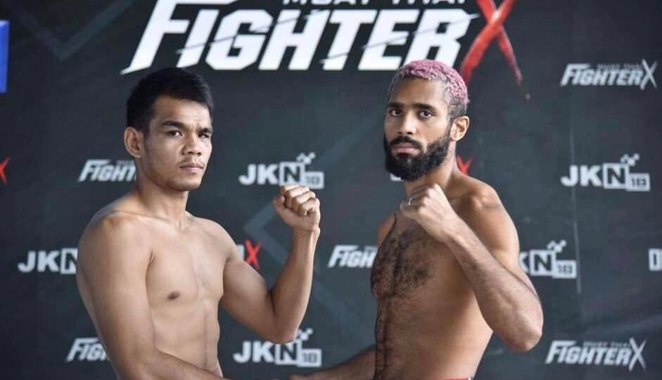 Parnpetch Phadungchai, at left, shakes hand with Anthony Durand before their match on July 15 at the Royal Thai Air Force Stadium.
