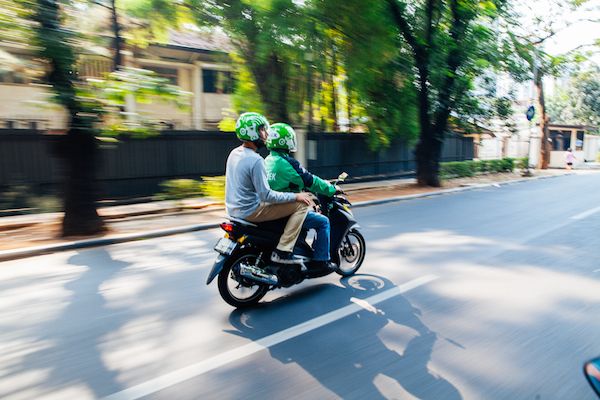 File photo of a Gojek driver with a passenger