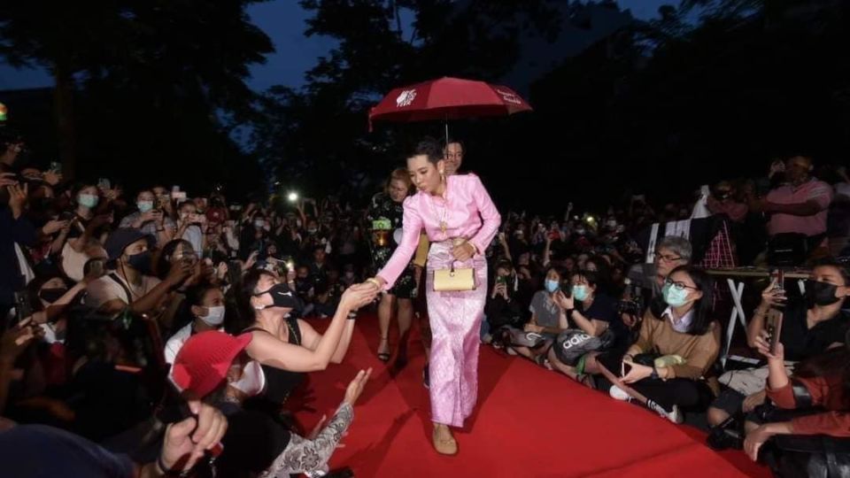 Jatuporn Saeoueng walks on a red carpet in a pink, traditional dress at an October 2020 protest. Photo: Jatuporn Saeoueng / Facebook