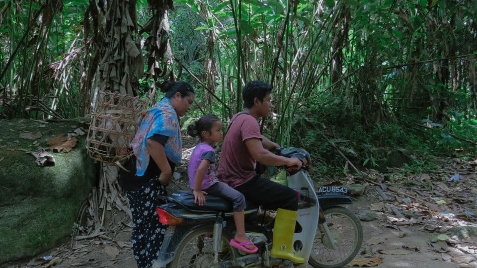 Photo: An Orang Asli couple with their child after working the morning shift at their Durian orchard in Ulu Geruh, Perak/Coconuts file pic
