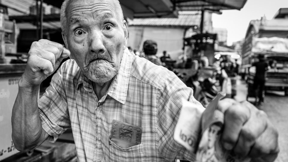 A retired muay Thai fighter poses at a market in Khlong Toei. Photo: Tim Russell / Courtesy