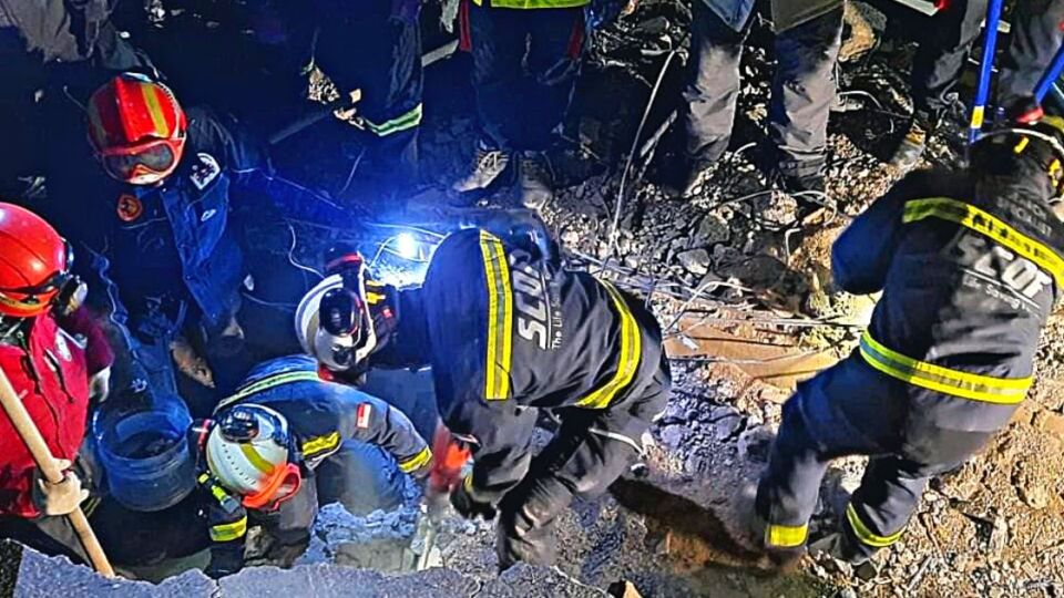 Members of Singapore Civil Defence Force working to rescue a boy trapped in a collapsed building in Turkey.  Photo: Singapore Civil Defence Force / Facebook.