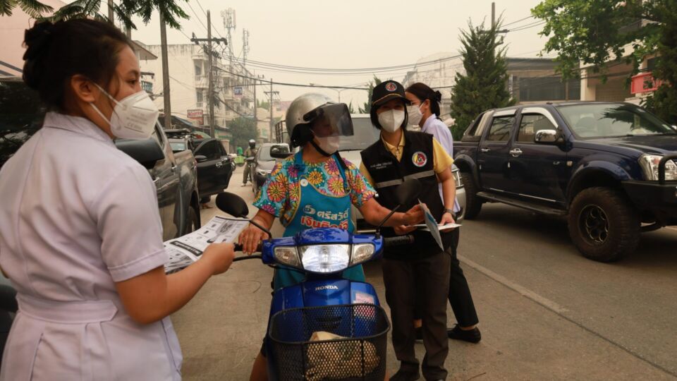 Government workers hand out face masks to residents in Chiang Rai province. Photo: Chiang Rai Provincial Office