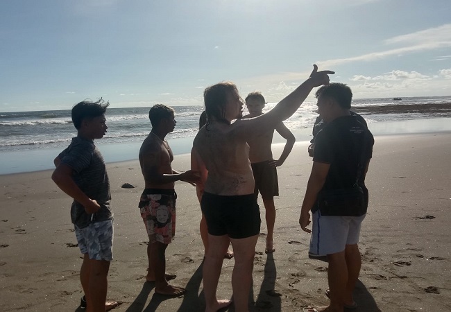 Several foreign nationals and local lifeguards at Pererenan Beach after a deadly incident in which a British man was killed after strong waves caught him while he went surfing there. Six others survived. Photo: Obtained. 