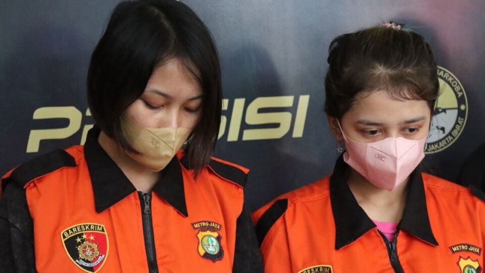 Two young Indonesian women arrested over nude live streams being paraded in front of journalists on March 14, 2023. Photo: National Police