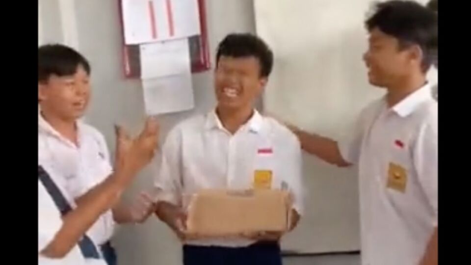 A junior high school student in Indonesia receiving a new pair of shoes from his friends, who pooled their money to replace his run-down kicks. Photo: Video screengrab