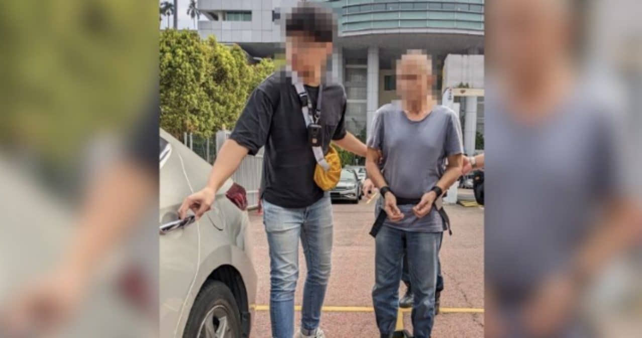 A 56-year-old man with a CNB officer yesterday. Photo: Central Narcotics Bureau (CNB)
