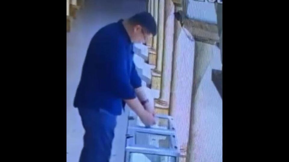 CCTV footage showing IM placing his QR code stickers on a donation box at a mosque in South Jakarta. Photo: Video screengrab