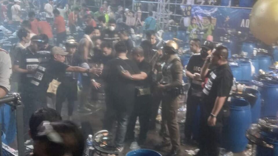 Police lead away a man believed to be the suspect in Monday morning’s shooting at Onyx nightclub’s Aquafest event in RCA. Photo: @My_1428_v2/Twitter