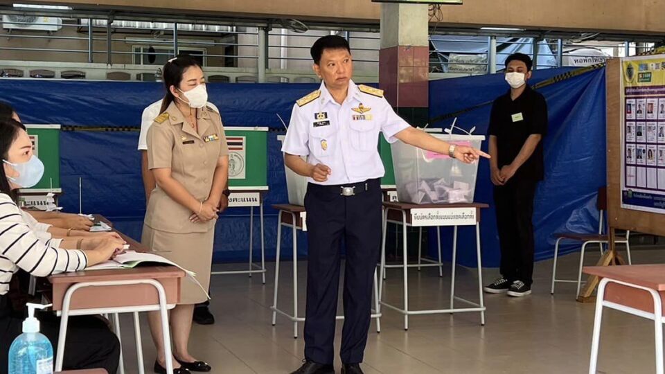 Poll workers gesture at a voting station in Bangkok’s Phaya Thai district. Photo: Election Commission