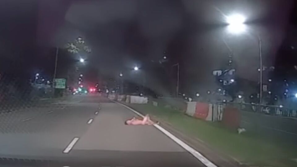 A man lying naked on a road in Sembawang on Friday. Photo: Sgfollowsall/Instagram
