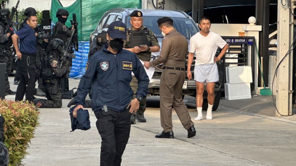 Deputy police chief Surachate “Big Joke” Hakparn seen wearing a white shirt and boxers at his home in Soi Vibahdi 60 as cyber police perform a raid on his home as part of bigger operation in which multiple police officers were allegedly found to have links with illegal online gambling websites. Photo: Noppakow Kongsuwan.