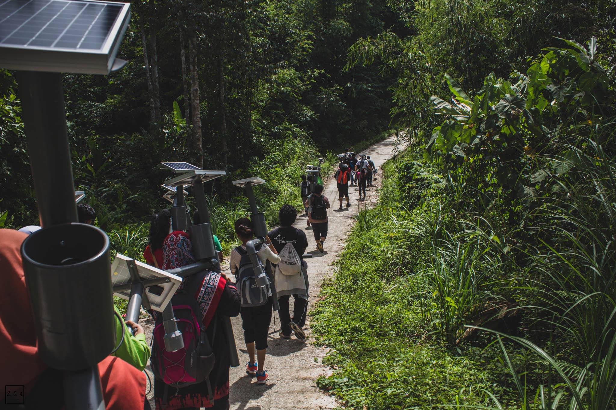 Materials being carried into villages for installation (Photo by Incitement)