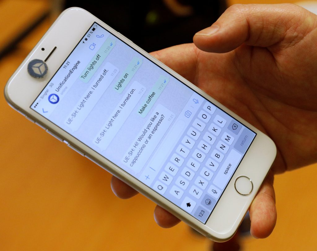 CEO of Unified Inbox Toby Ruckert demonstrates how he uses his smartphone to control electrical appliances in a simulation software. 