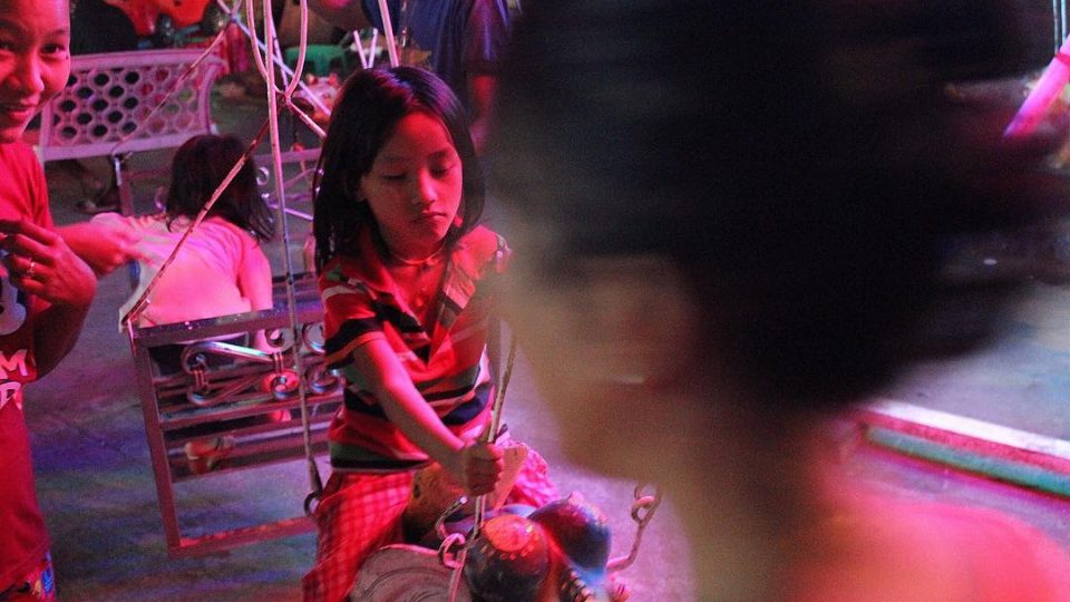 A child rides a carousel in Sanchaung. Photo: Jacob Goldberg