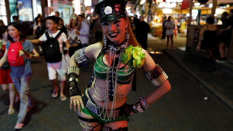 A woman promotes a go-go dance bar in Pattaya, March 25, 2017. Jorge Silva/ Reuters