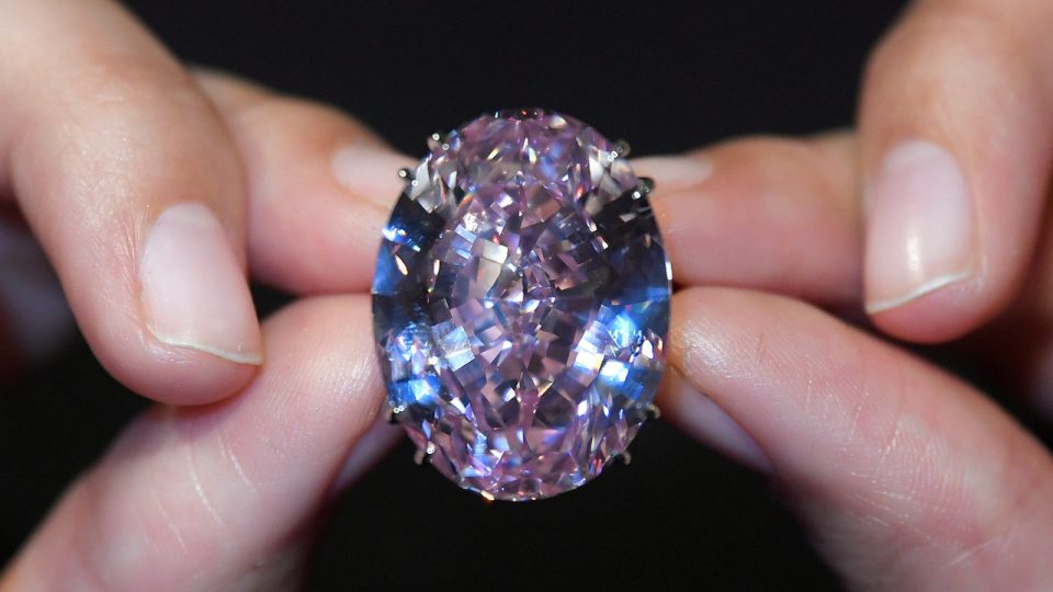 A model poses with a 59.60-carat mixed cut diamond known as “The Pink Star”, the largest Internally Flawless Fancy Vivid Pink diamond ever graded by the Geological Institute of America (GIA), ahead of being auctioned in Hong Kong by Sotheby’s. File photo: Toby Melville/Reuters